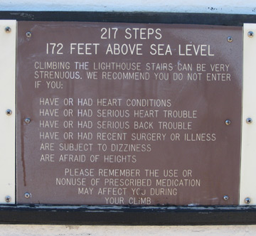 a sign explaining heath problems that should preclude one from walking the lighthouse stairs